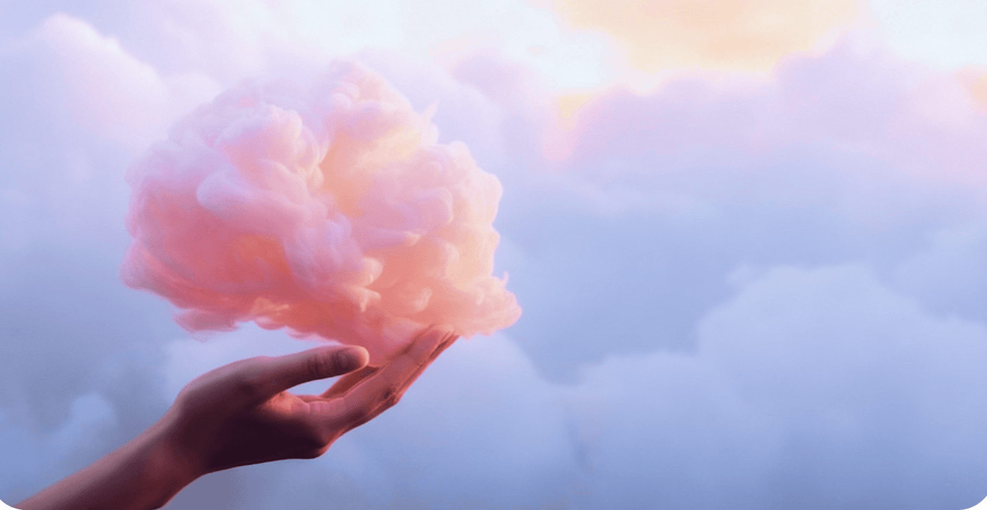 Main douce tenant un nuage rose représentant le bien-être